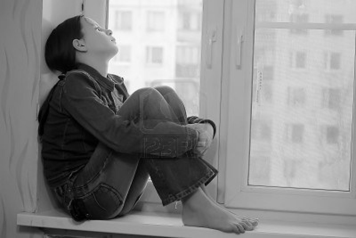 14190823-the-sad-girl-the-teenager-at-home-on-a-window-sill